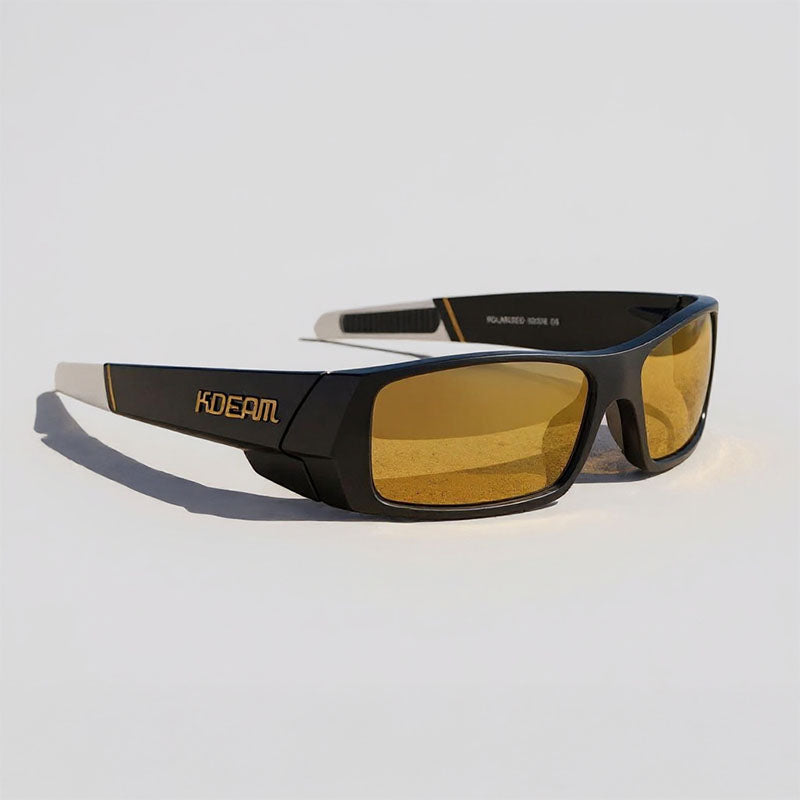 Sunglasses with gold lenses and black frame on a light gray background