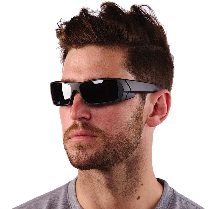 Man wearing black sunglasses with a neutral background