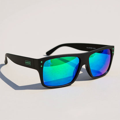 Fishing sunglasses with black frame and green-tinted lenses on a light gray background