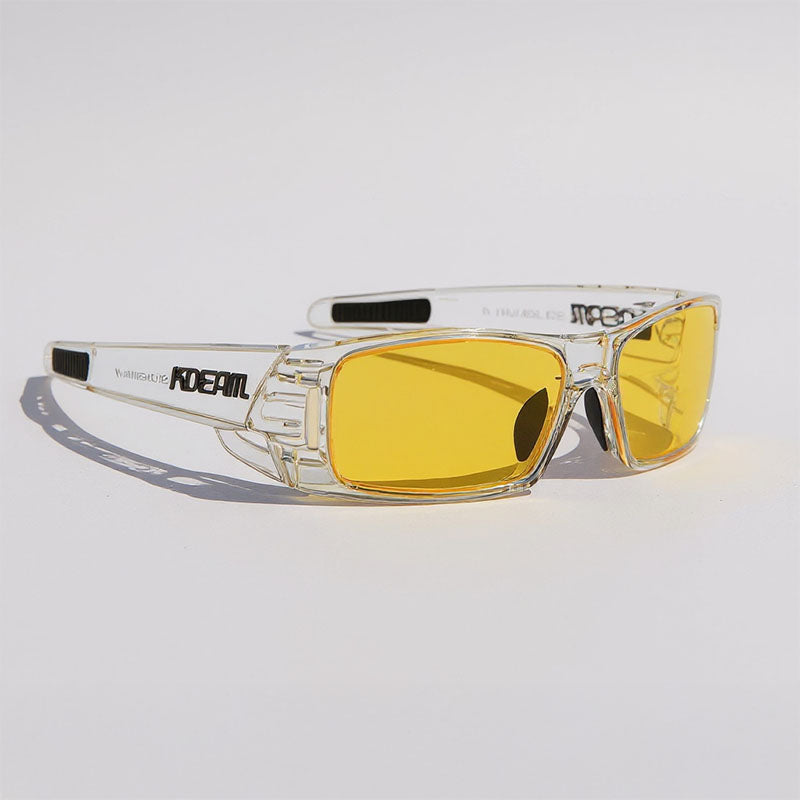 Clear frame sunglasses with yellow lenses on a light gray background