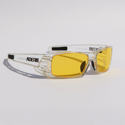 Clear frame sunglasses with yellow lenses on a light gray background
