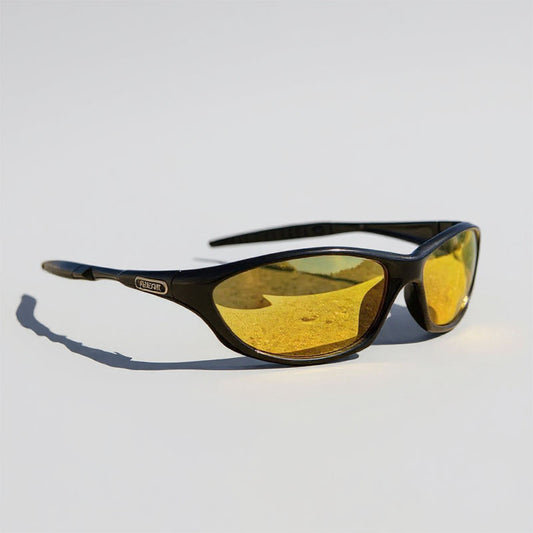 Sunglasses with yellow lenses and black frame on a light gray background